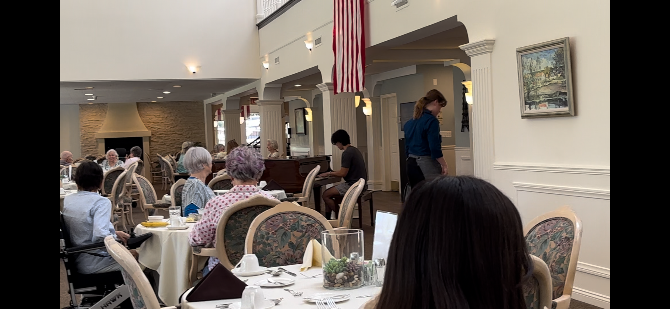 Liam performing piano in a dining room