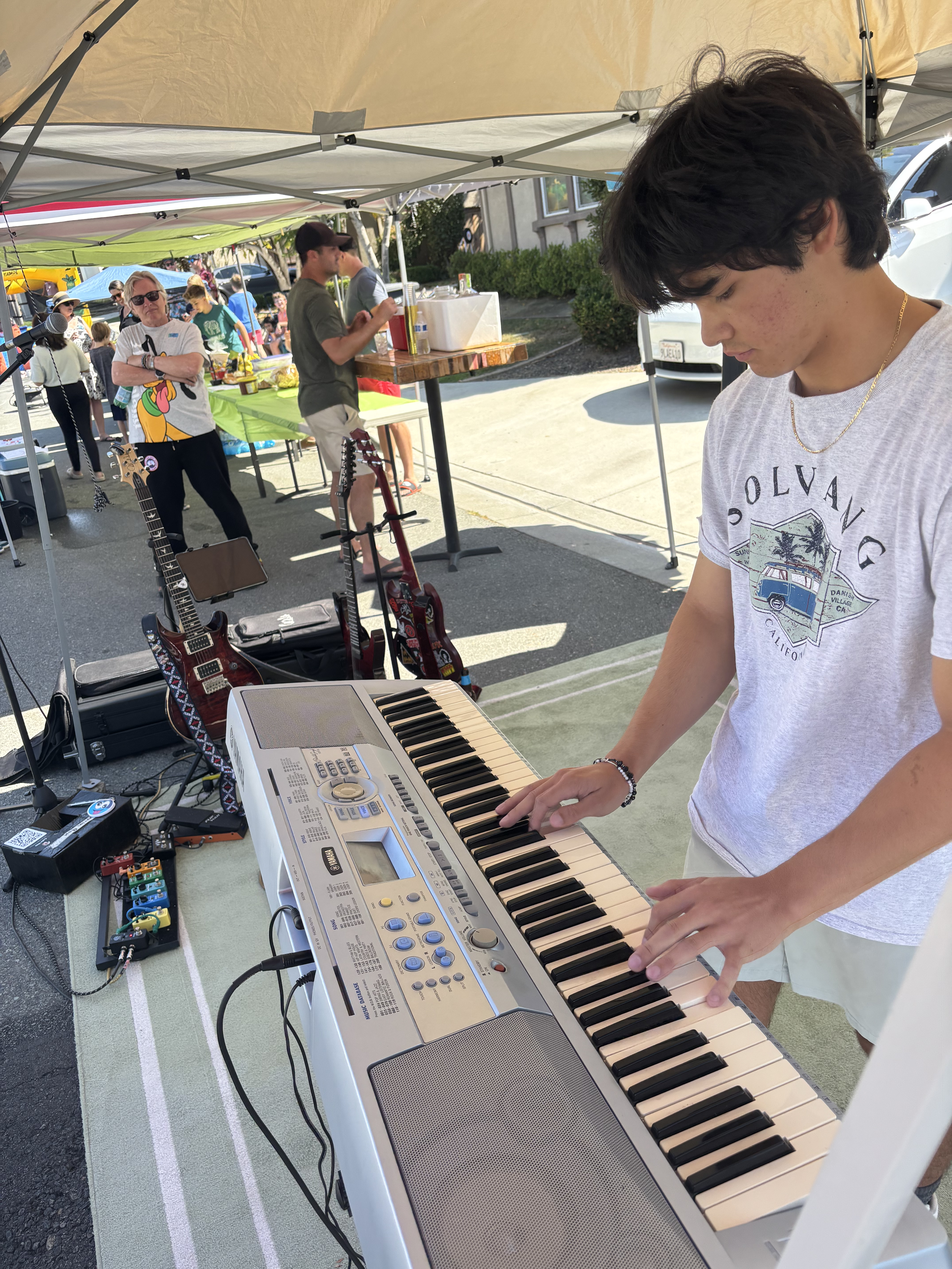 Liam playing keyboard at a neighborhood event